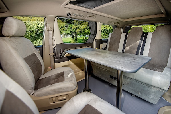 table and chairs inside eco friendly hybrid toyota campervan