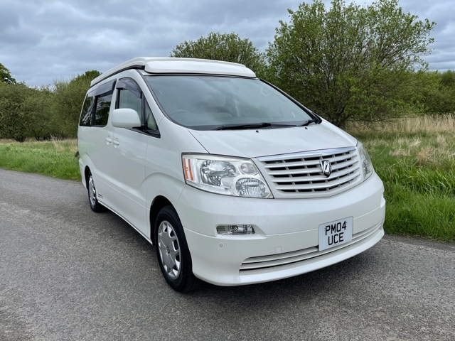 White Toyota Alphard Campervan for sale, parked on country road