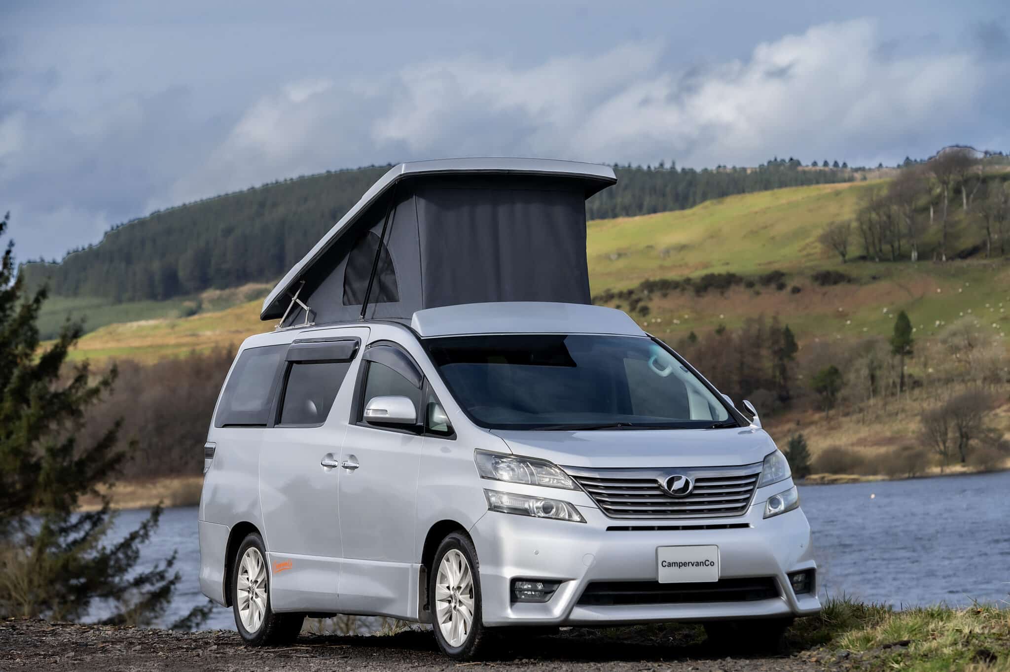 Toyota Alphard Connect II Campervan in mountain area with roof up next to loch