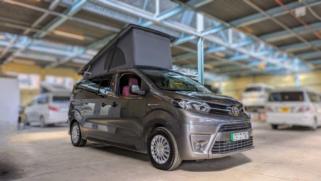 Fully electric, zero-emissions Eco Revolution 7 seater campervan grey parked in cool workshop