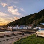 Toyota Hybrid Eco Escape at sunset on beach with roof up