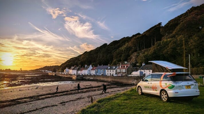 Toyota Hybrid Eco Escape at sunset on beach with roof up