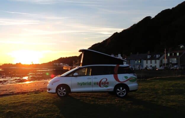 Toyota Hybrid Eco Escape with roof up on beach sunset